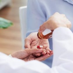 A nurse is administering medications to four clients